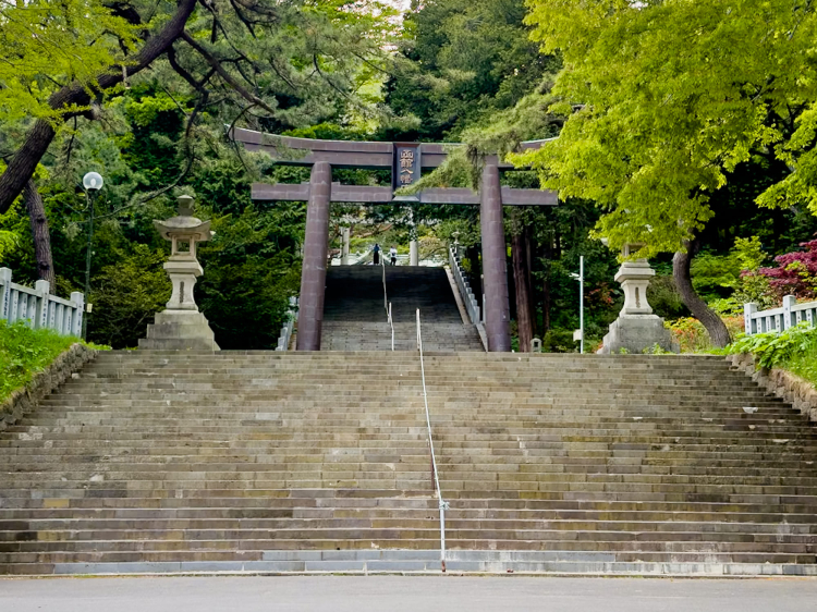 The second torii gate in front of the stairs leading to the shrine has a massive relief of "Hakodate Hachiman Shrine" on it.