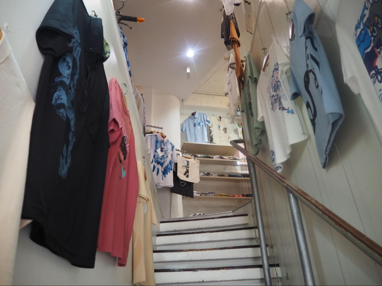 T-shirts with various designs line the stairs