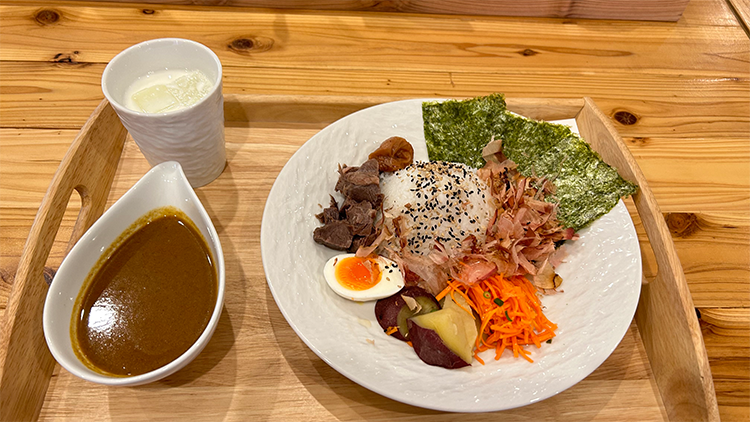 Beef curry topped with pickled plum and seaweed