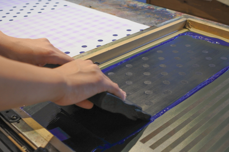 The ink is applied to the tenugui cloth.