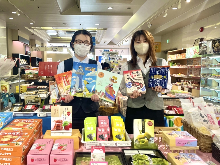 Kanegae-san (left) and Yamaguchi-san (right) holding recommended products