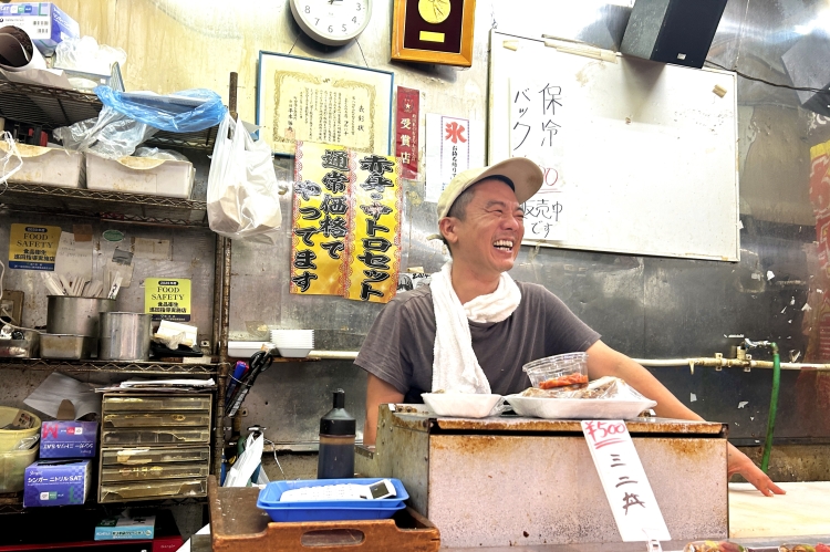 The store manager, Mr. Komatsu, always has a smile on his face