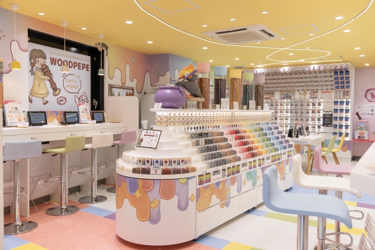 A large shelf designed to resemble a ship stocks over 60 types of sealing wax.
