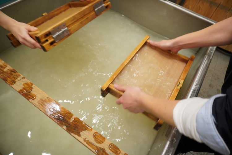 Part of the pouring process. Water mixed with the raw materials is drawn deep into the ground to entangle the fibers.