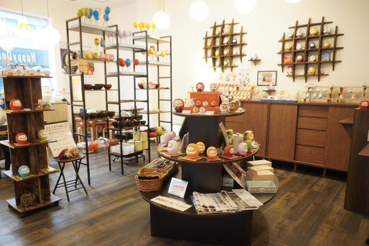 The shop is filled with colorful and adorable Daruma dolls.