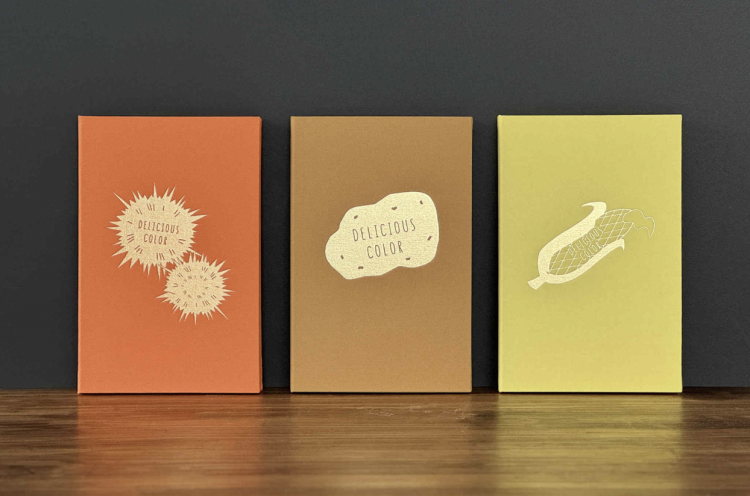 A notebook that showcases the essence of Hokkaido. From left to right: "Sea urchin," "Potato," and "Corn."