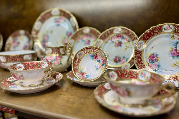An eye-catching cup and saucer from "Old Noritake" featuring gold accents and a vibrant rose design.