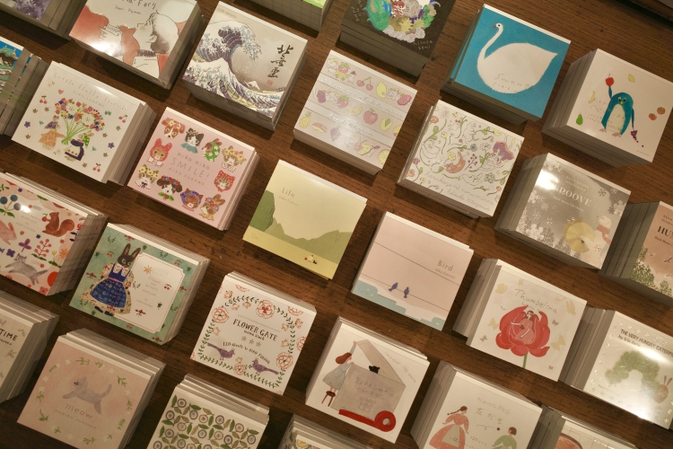 Notebooks from various authors are lined up.