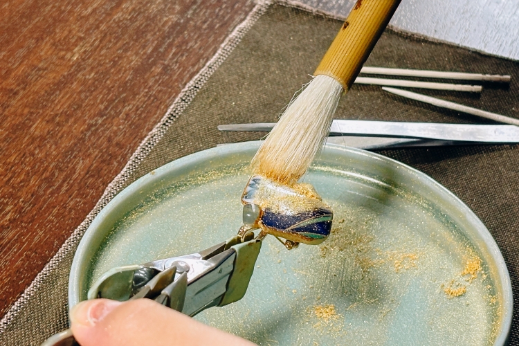 The act of sprinkling gold powder