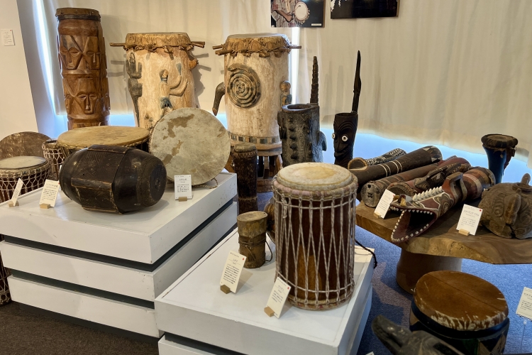The exhibition features drums and percussion instruments from around the world, varying in shape and material.