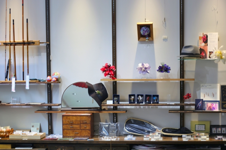 The store is filled with feather accessories such as necklaces, brooches, and earrings.